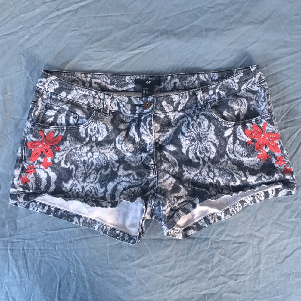 Gray patterned shorts, red embroidered accents